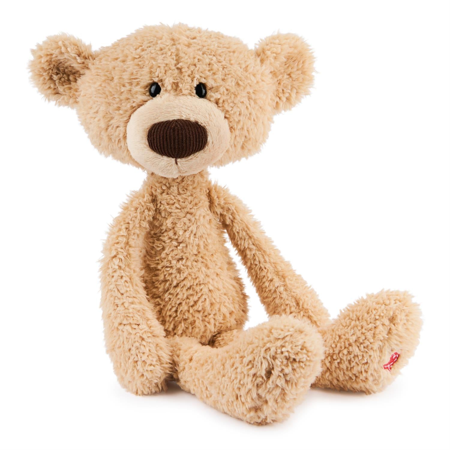 Stuffed teddy bear with tan fur and brown nose.