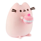 Pink plush cat toy holding a pink and white cupcake.