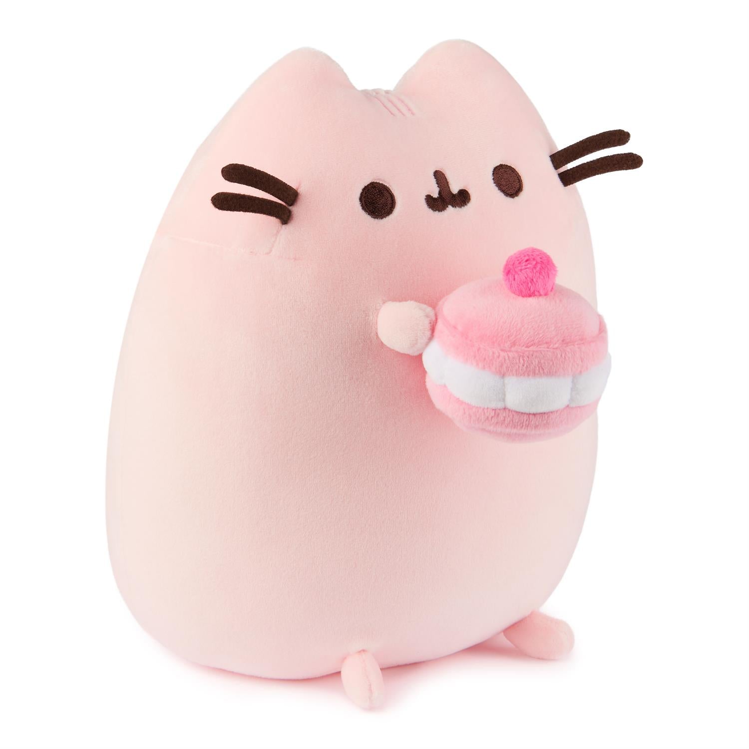Pink plush cat toy holding a pink and white cupcake.