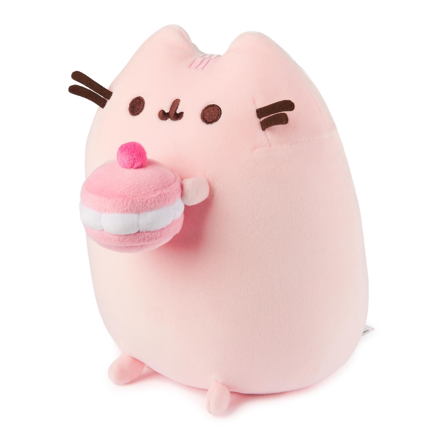 Pink Pusheen cat plushie holding a pink cupcake.
