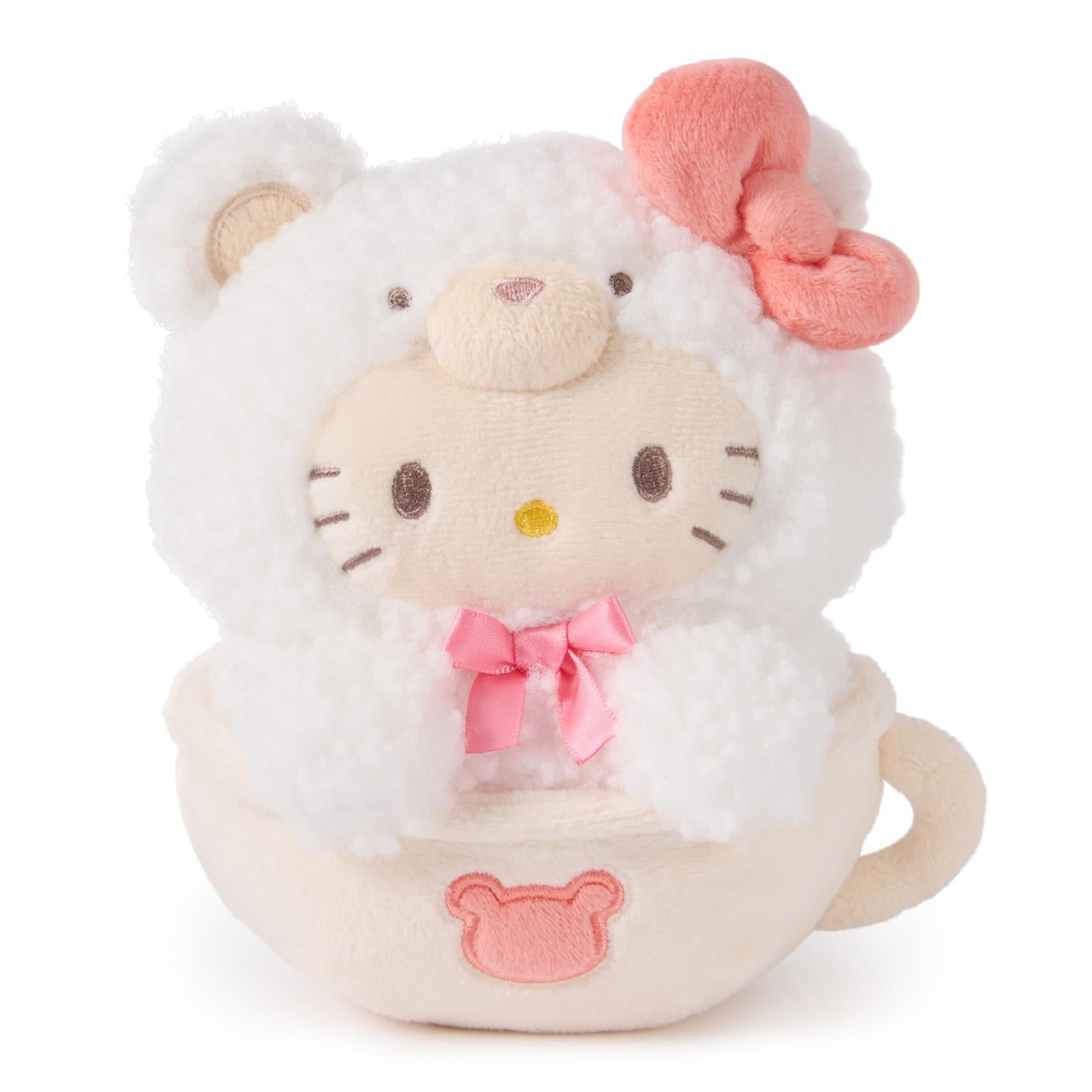 Stuffed Hello Kitty toy in a teacup, wearing a fluffy white bear costume with a pink bow.