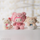 Three stuffed toys in tea cups, Hello Kitty, My Melody, and Cinnamoroll.