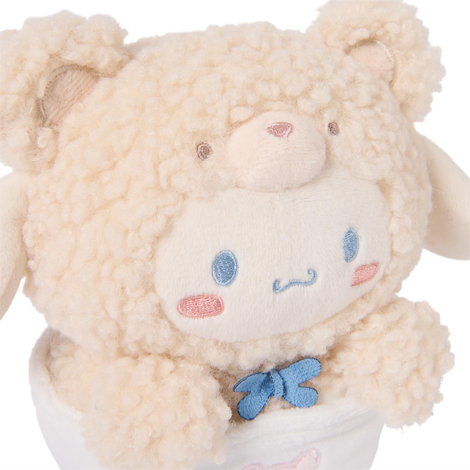 Cream-colored, plush, stuffed animal with a light blue bow tie.