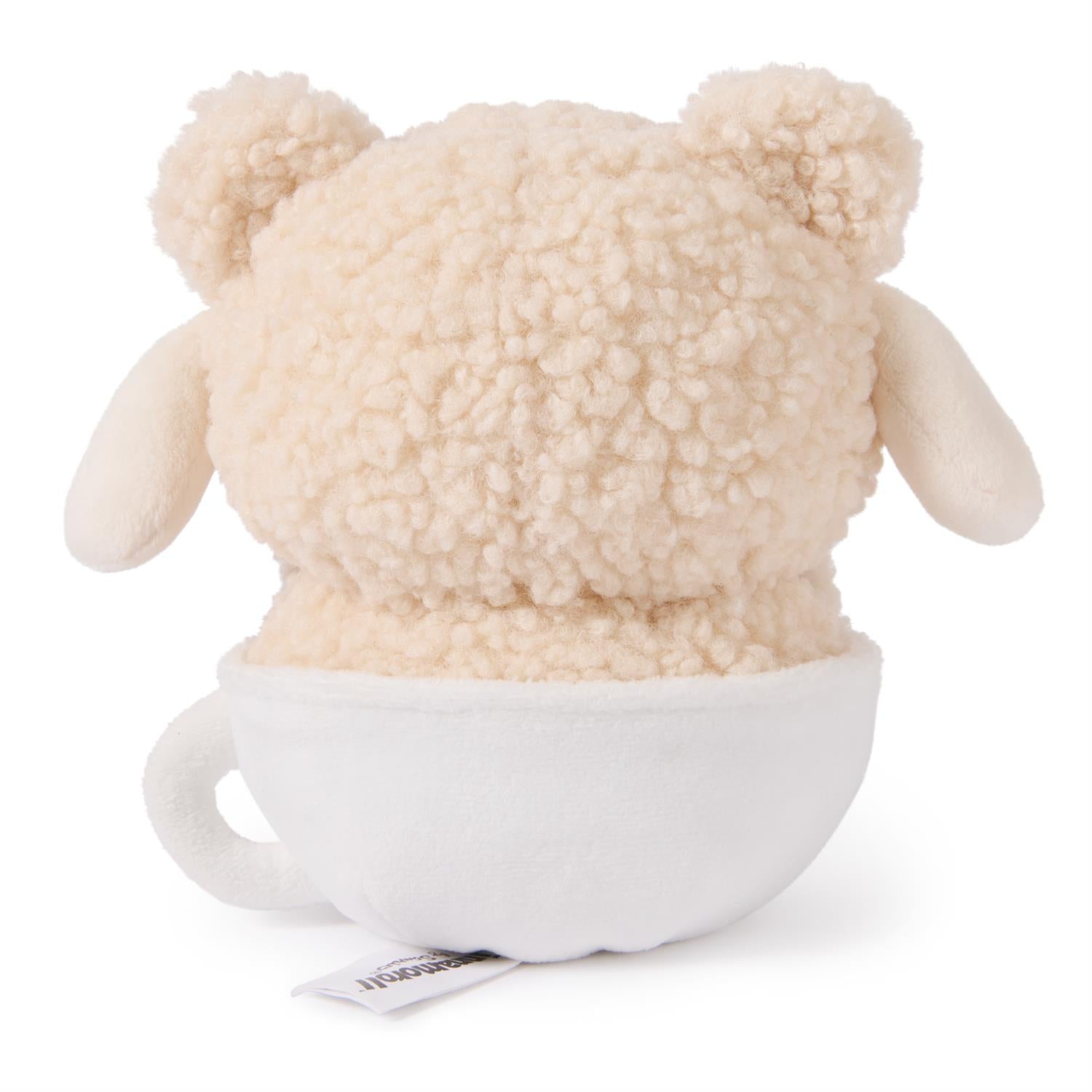 Back view of a stuffed teddy bear toy in a white cup.