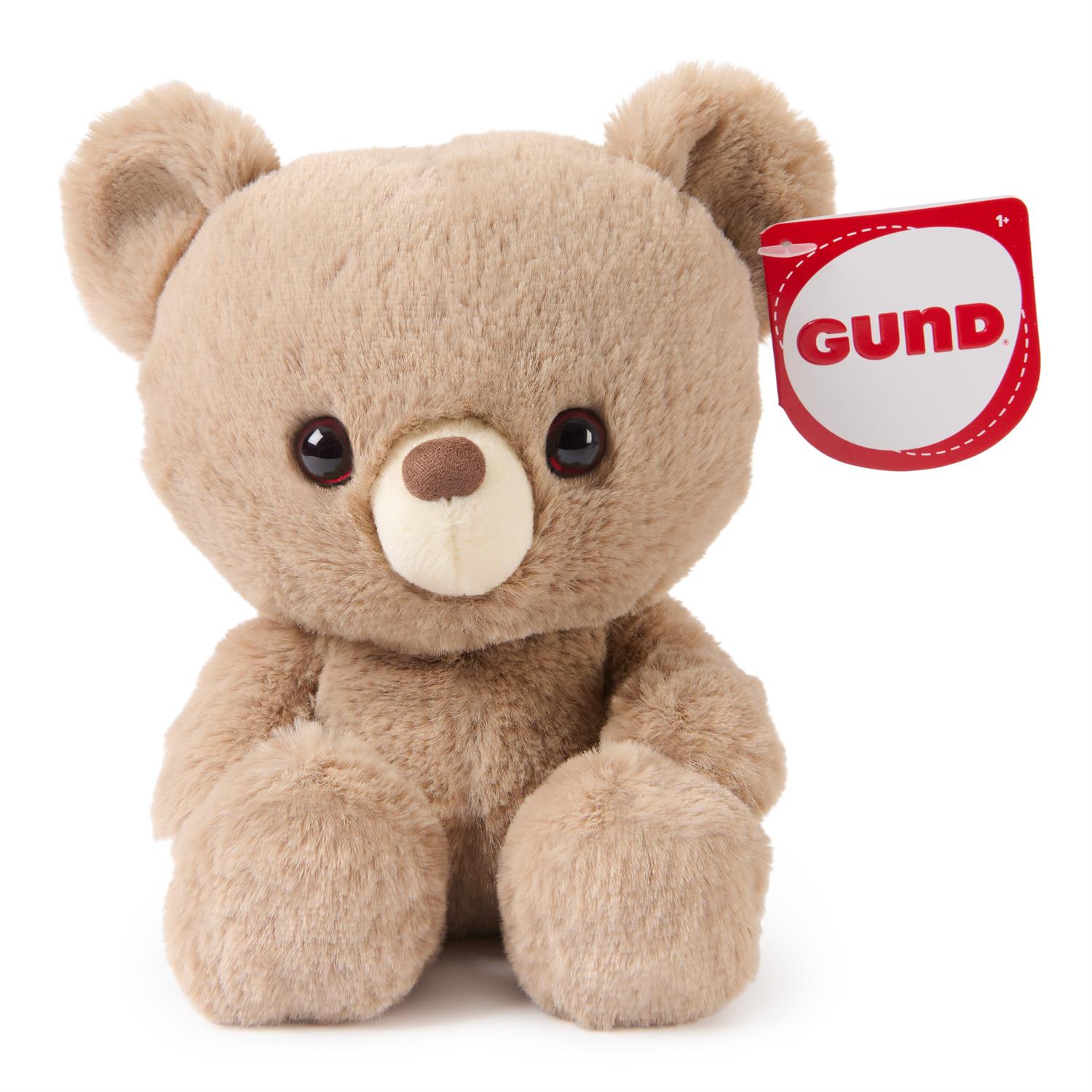 Brown plush Gund teddy bear with a red tag.