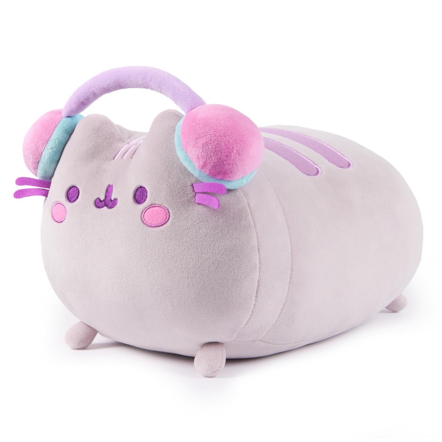 Gray plush Pusheen cat wearing pink and blue headphones.