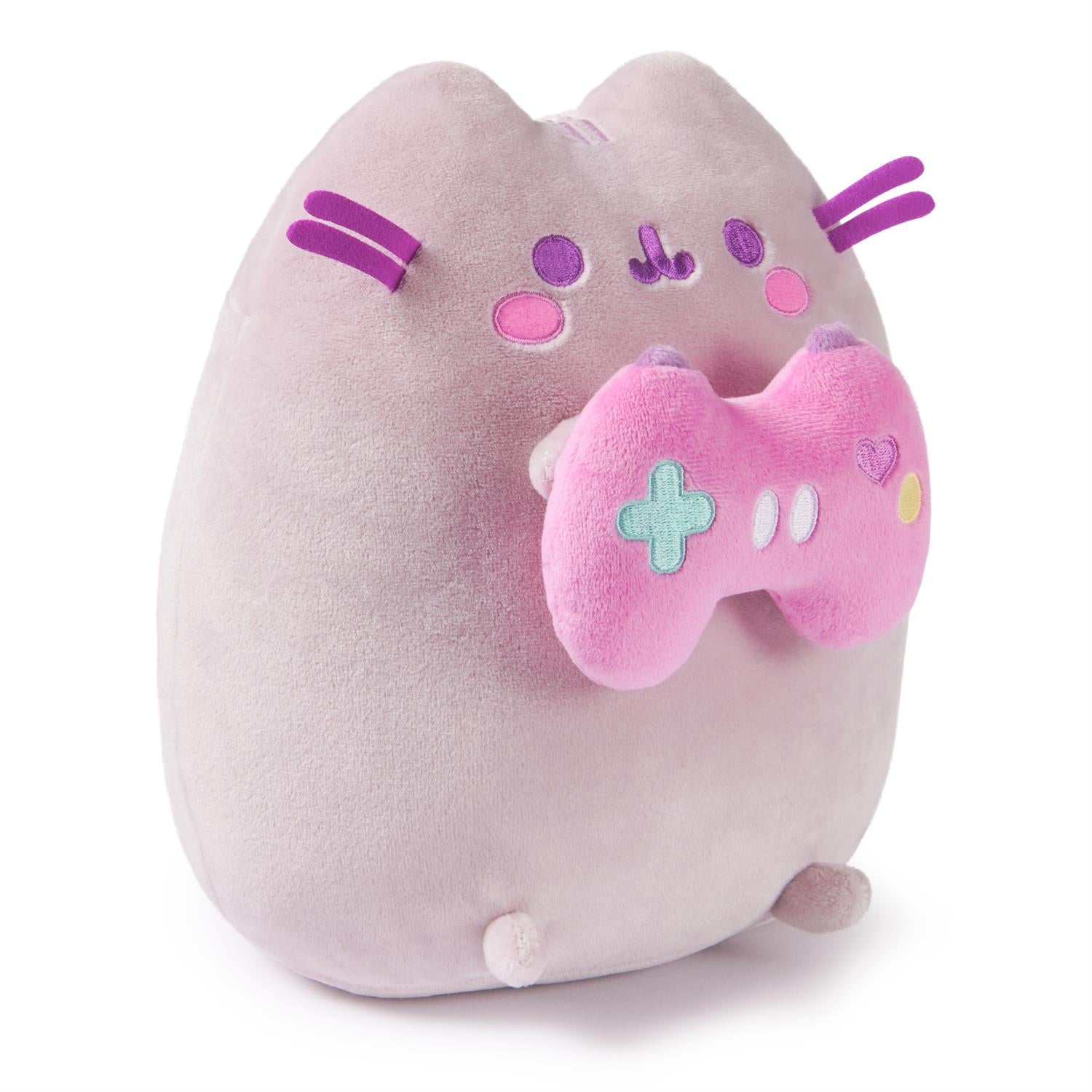Plush cat holding pink video game controller.