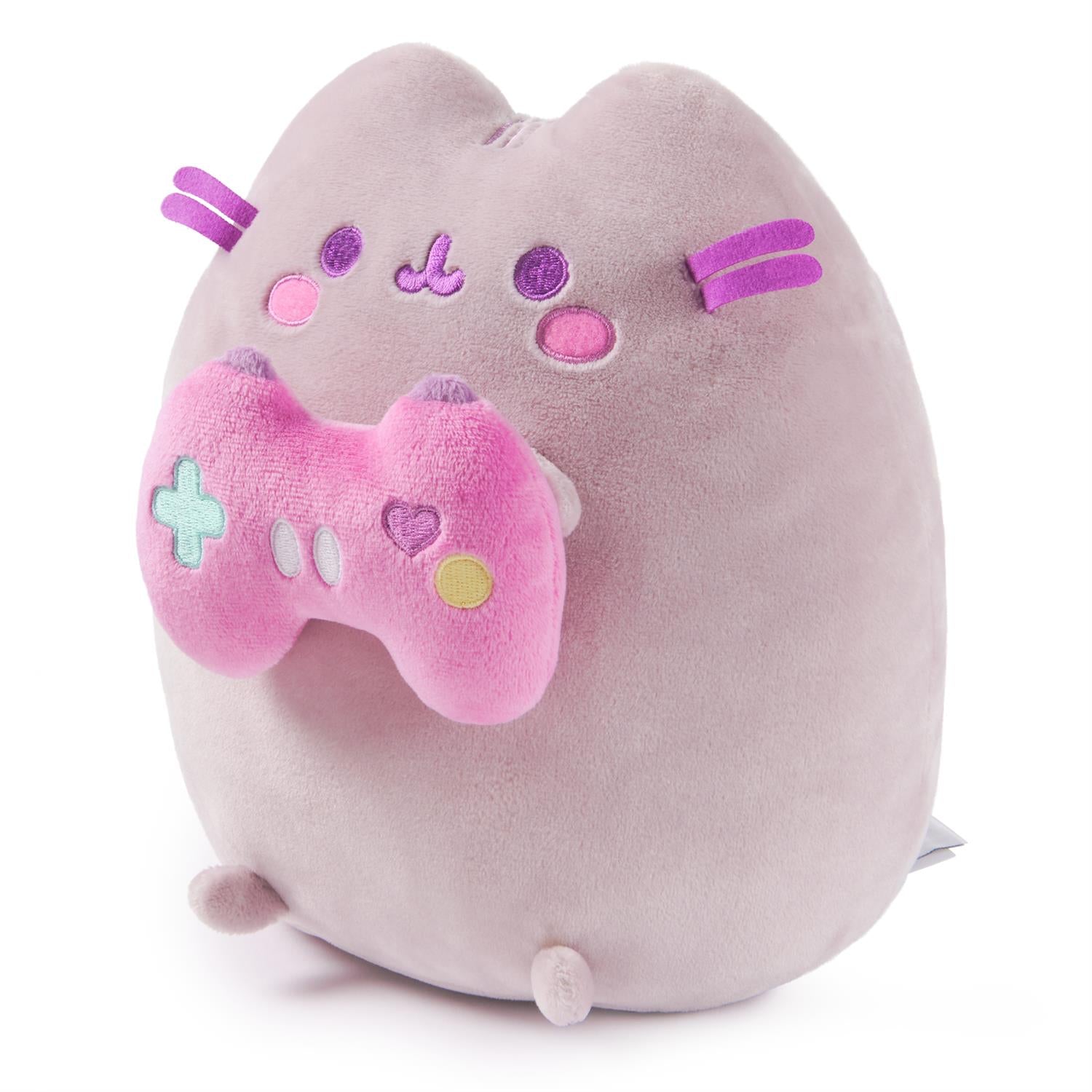 A light purple plush Pusheen cat holding a pink game controller.