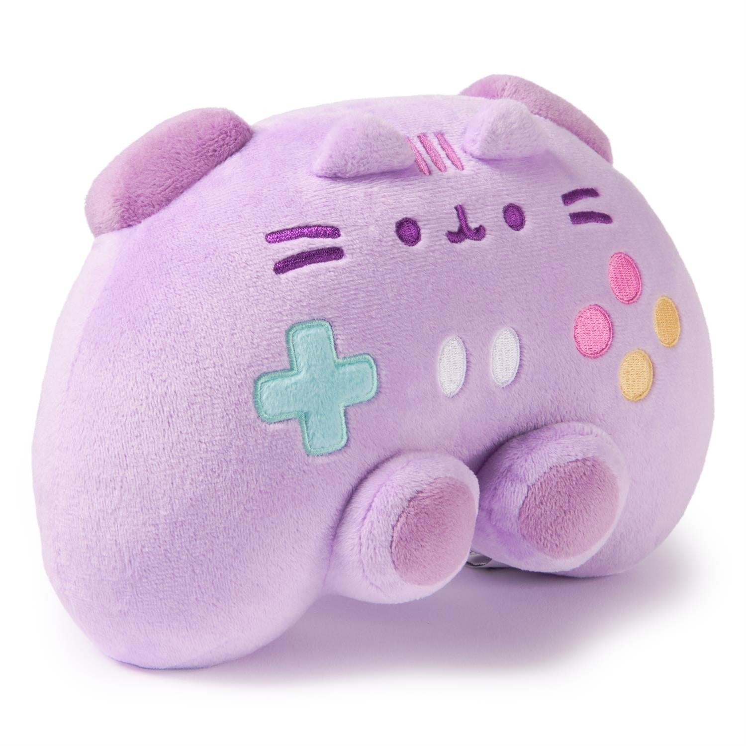 A purple plush toy shaped like a cat and a game controller.