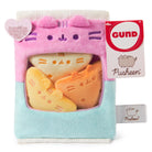 Pink and blue Pusheen plush toy in a box, with three removable cat-shaped plushies inside. A tag with the Gund logo and Pusheen's name is attached.