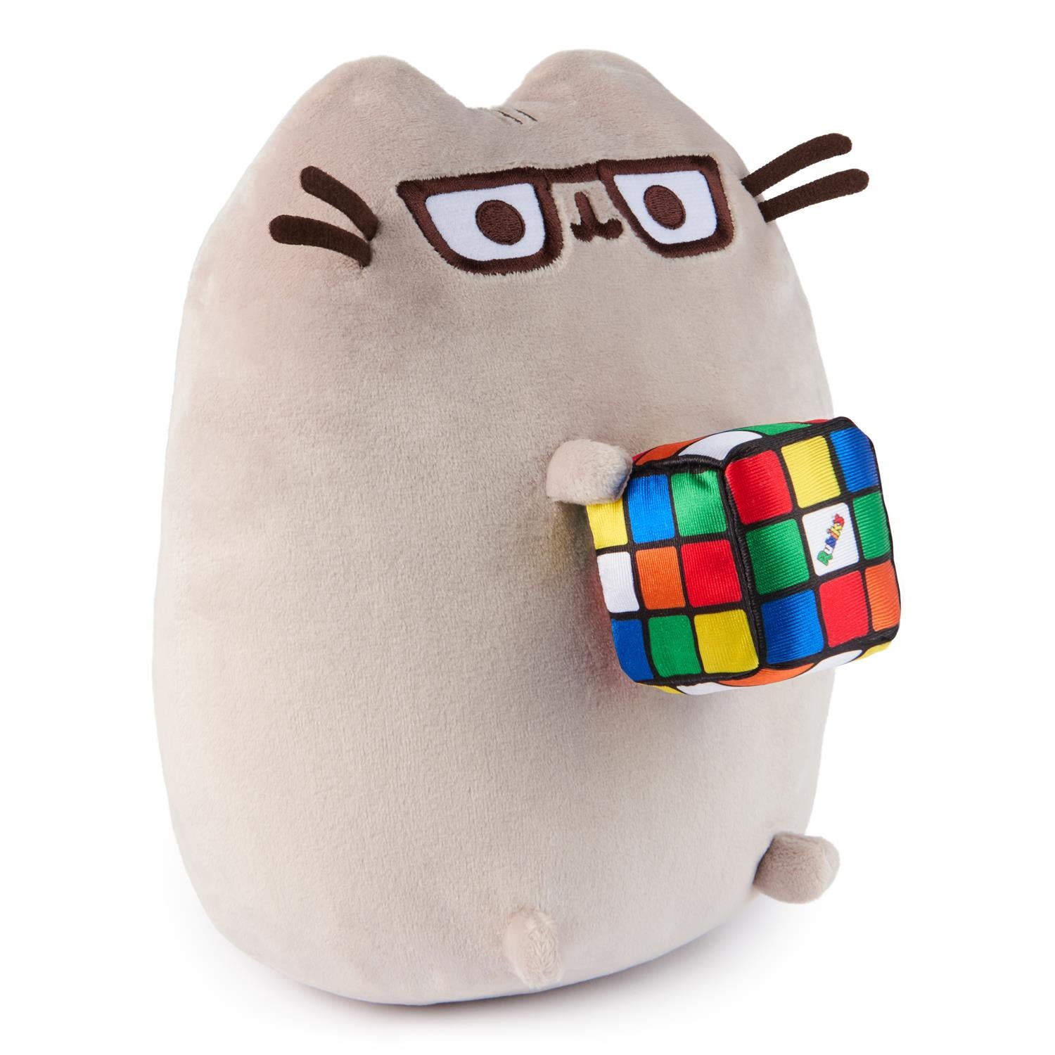 Tan plush Pusheen cat toy with glasses, holding a Rubik's cube.
