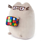 Stuffed gray cat wearing glasses and holding a Rubik's Cube.