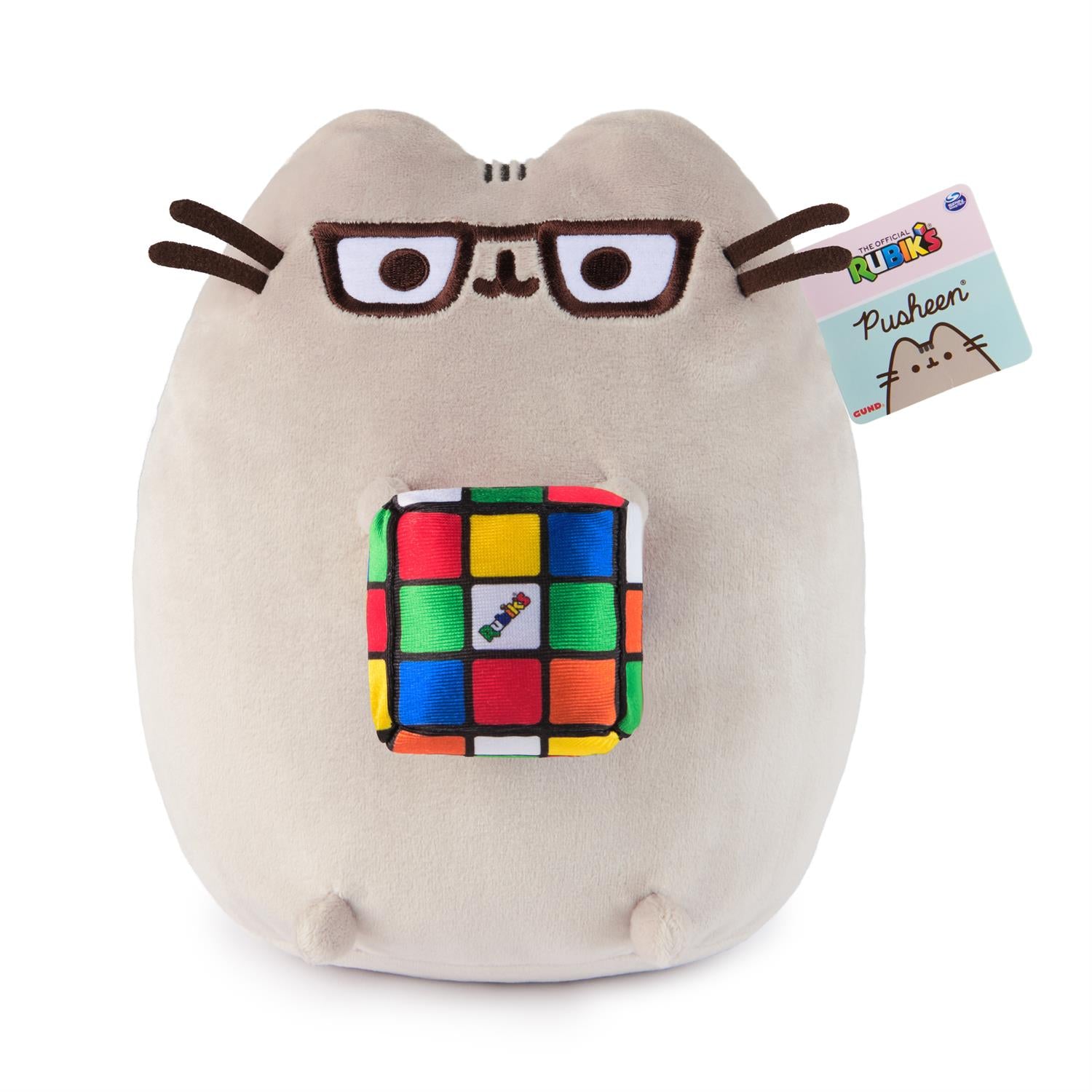 Stuffed Pusheen cat wearing glasses and holding a Rubik's cube.