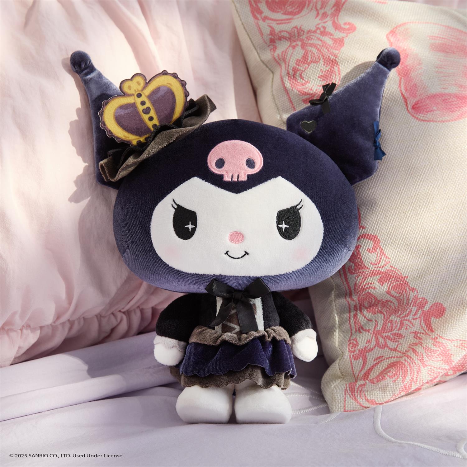 Kuromi plush with crown and frilly outfit.