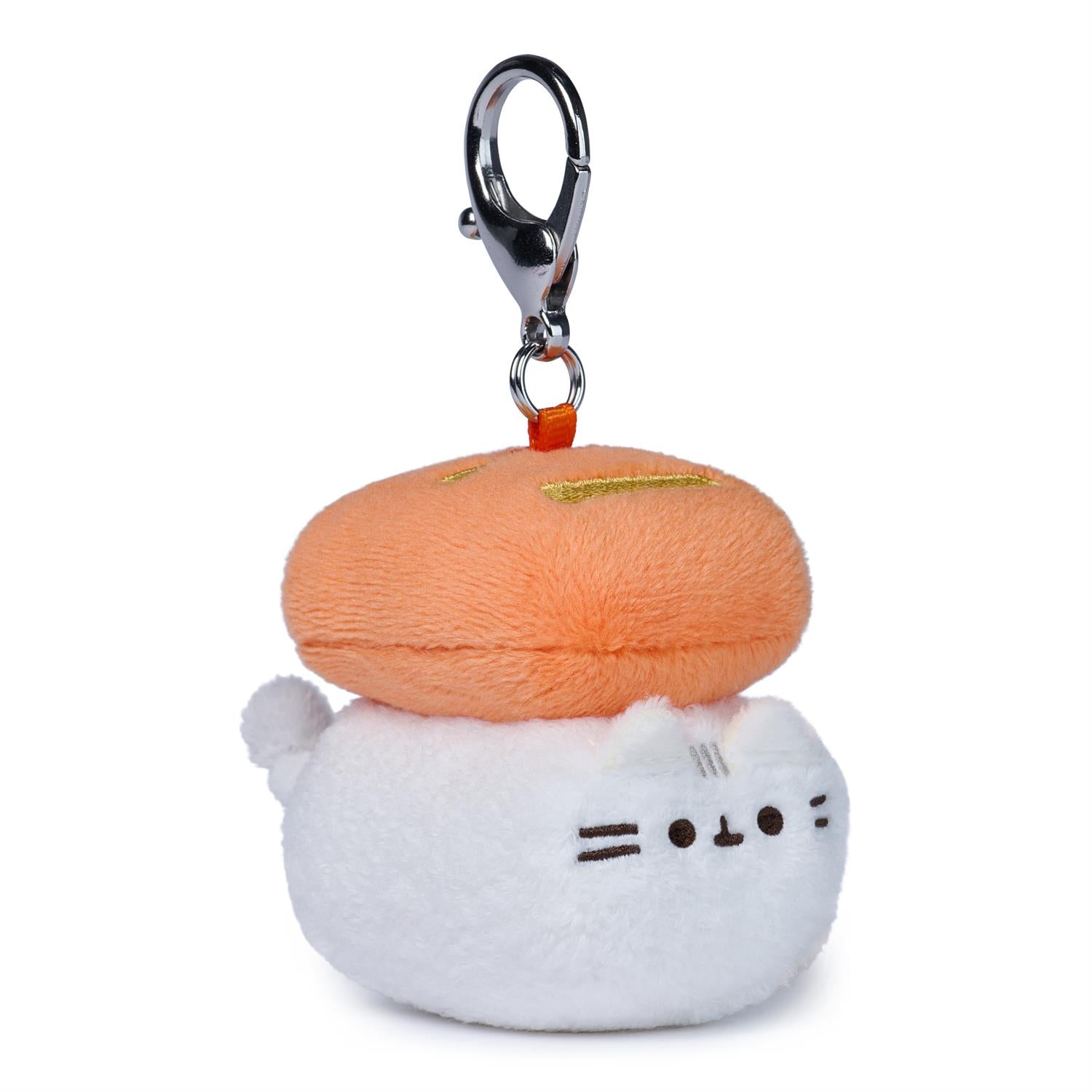 Plush keychain with a white cat-like face and orange hat on a white background