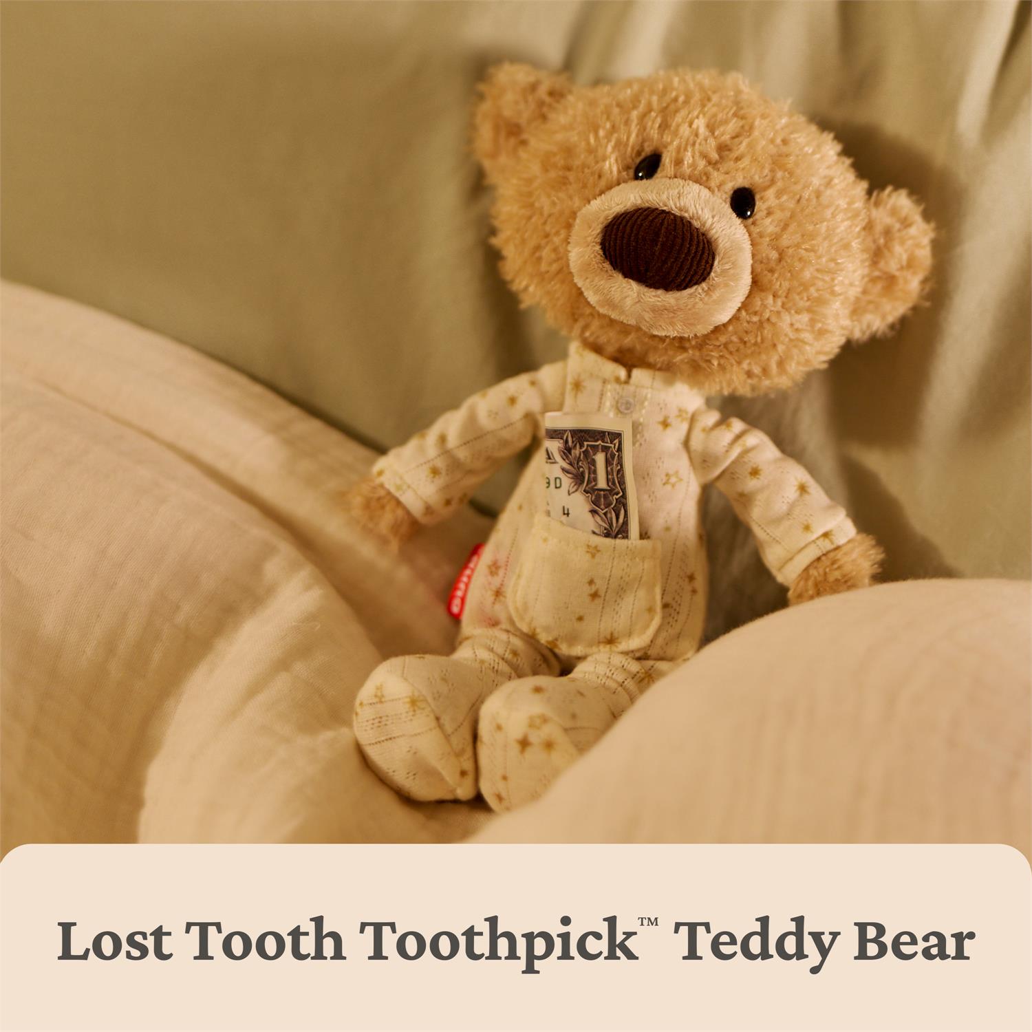 Teddy bear with a toothpick in its pocket on a beige background
