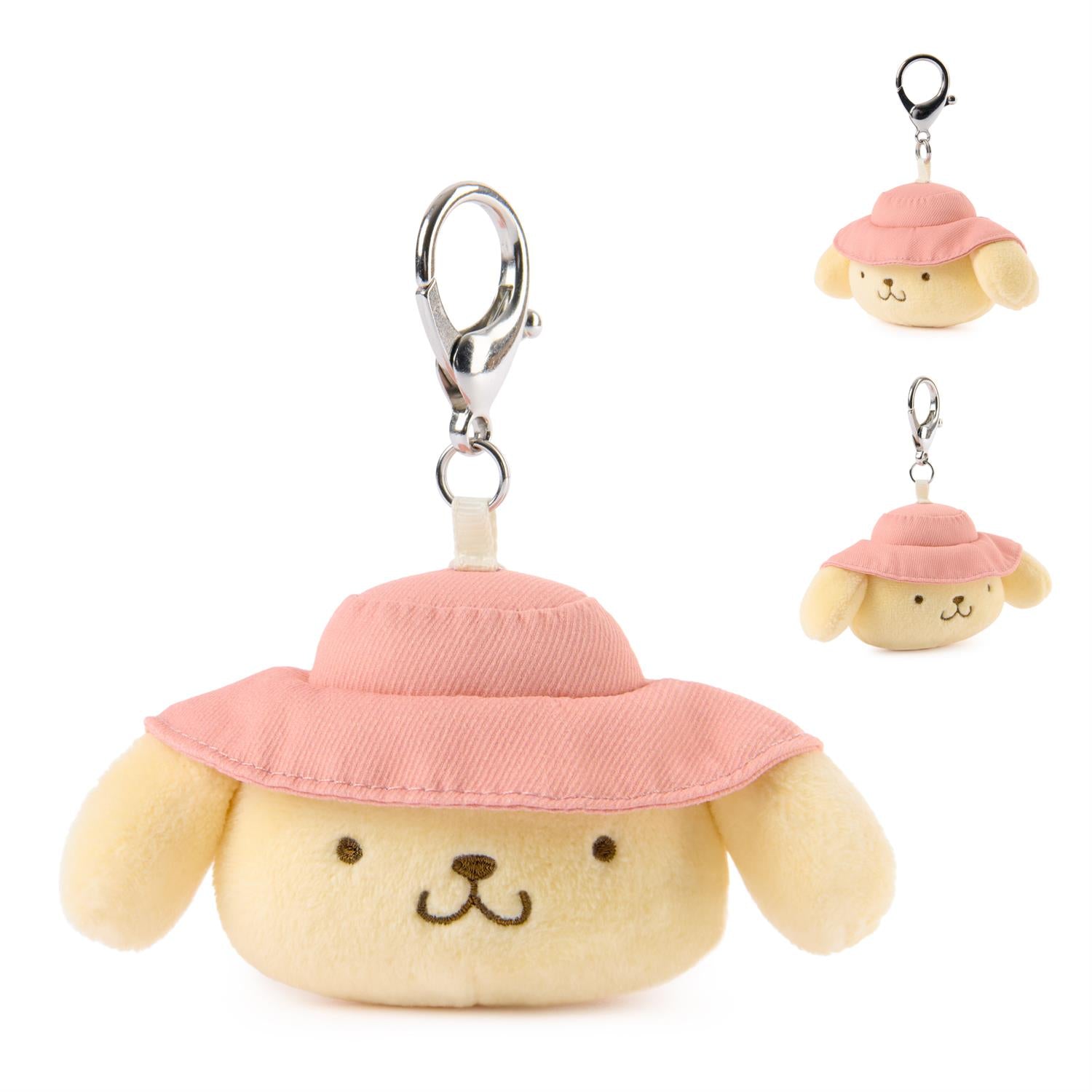 Plush dog toy with a pink hat attached to a keychain on a white background
