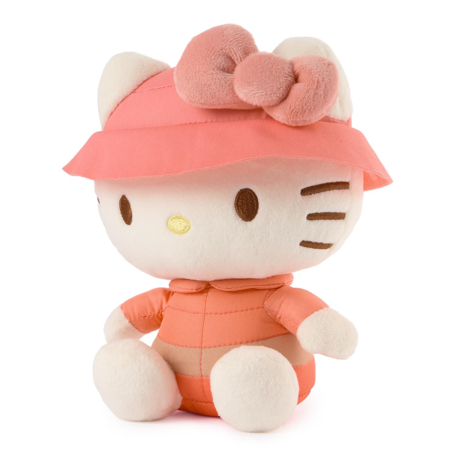Plush toy resembling a character with a pink hat and outfit on a white background