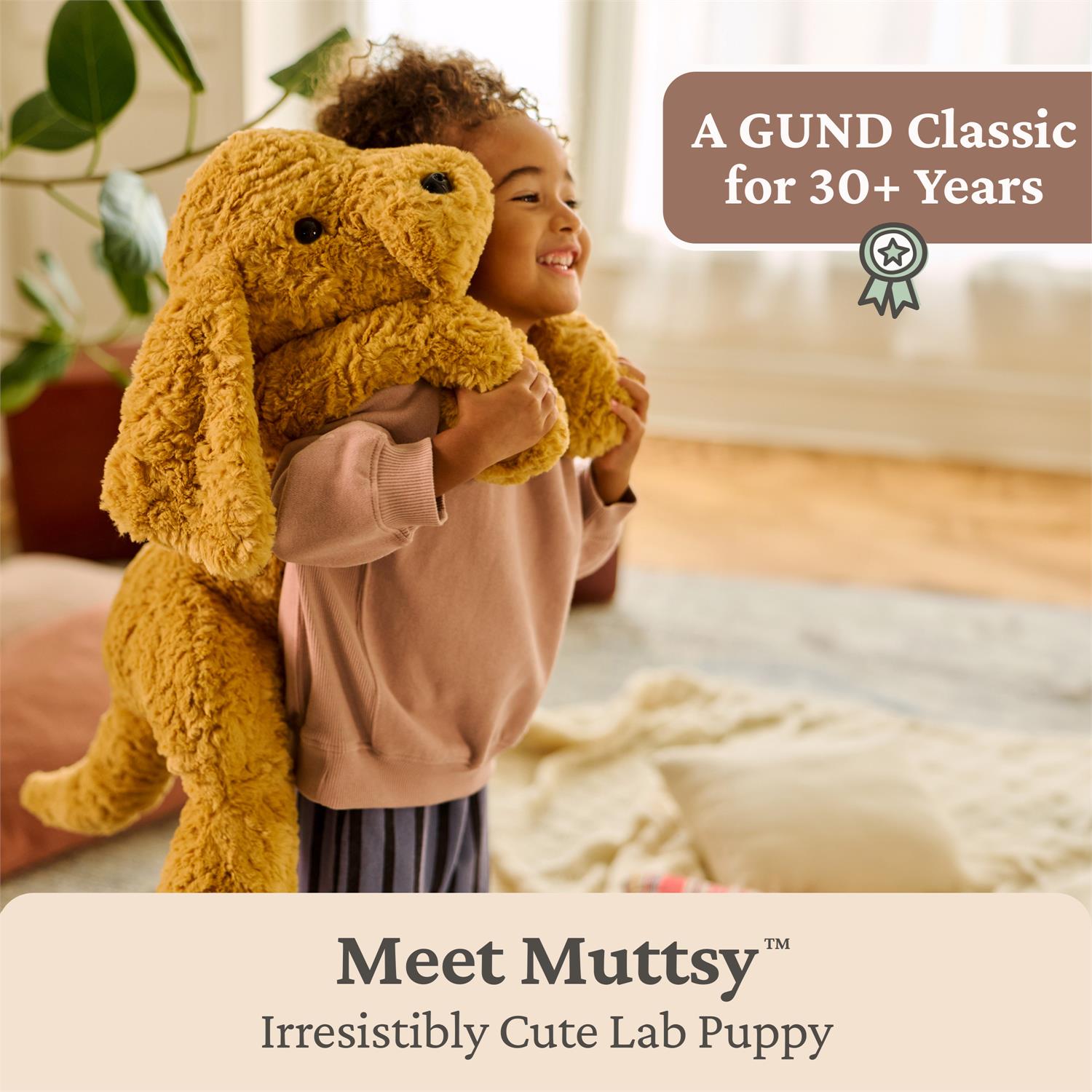 Child holding a large yellow stuffed dog toy with text about GUND's Muttsy toy.