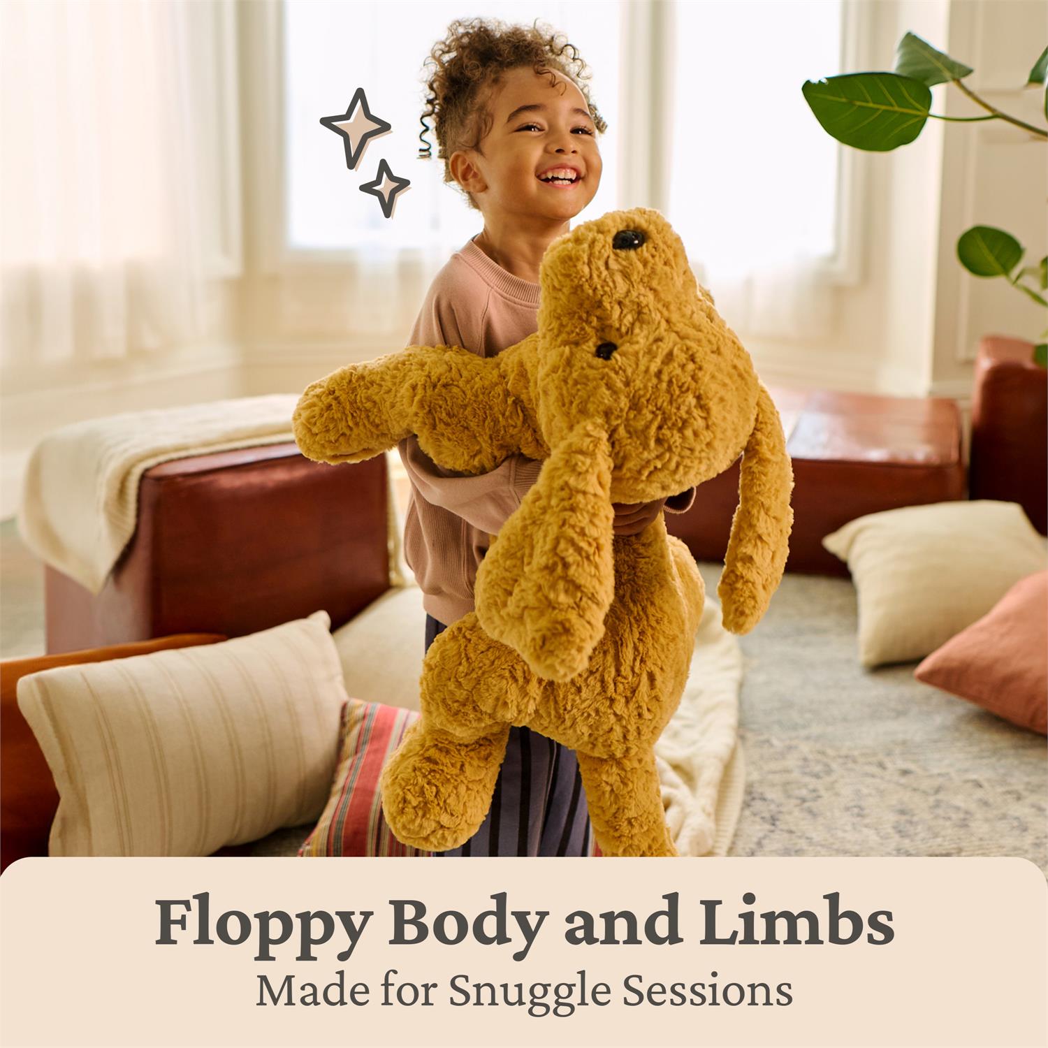 Child holding a large brown teddy bear in a cozy living room.
