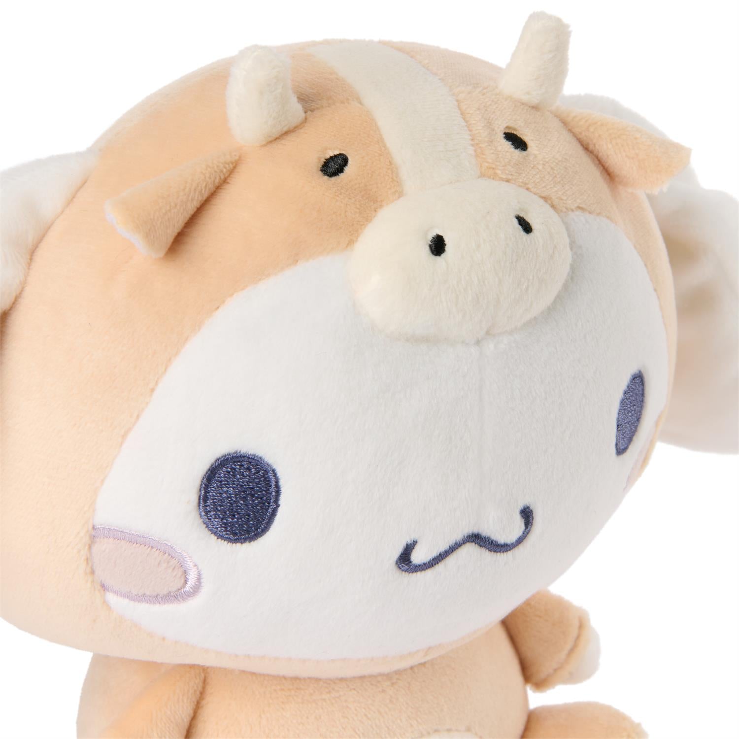 Plush toy cow with a white face and purple spots on a white background