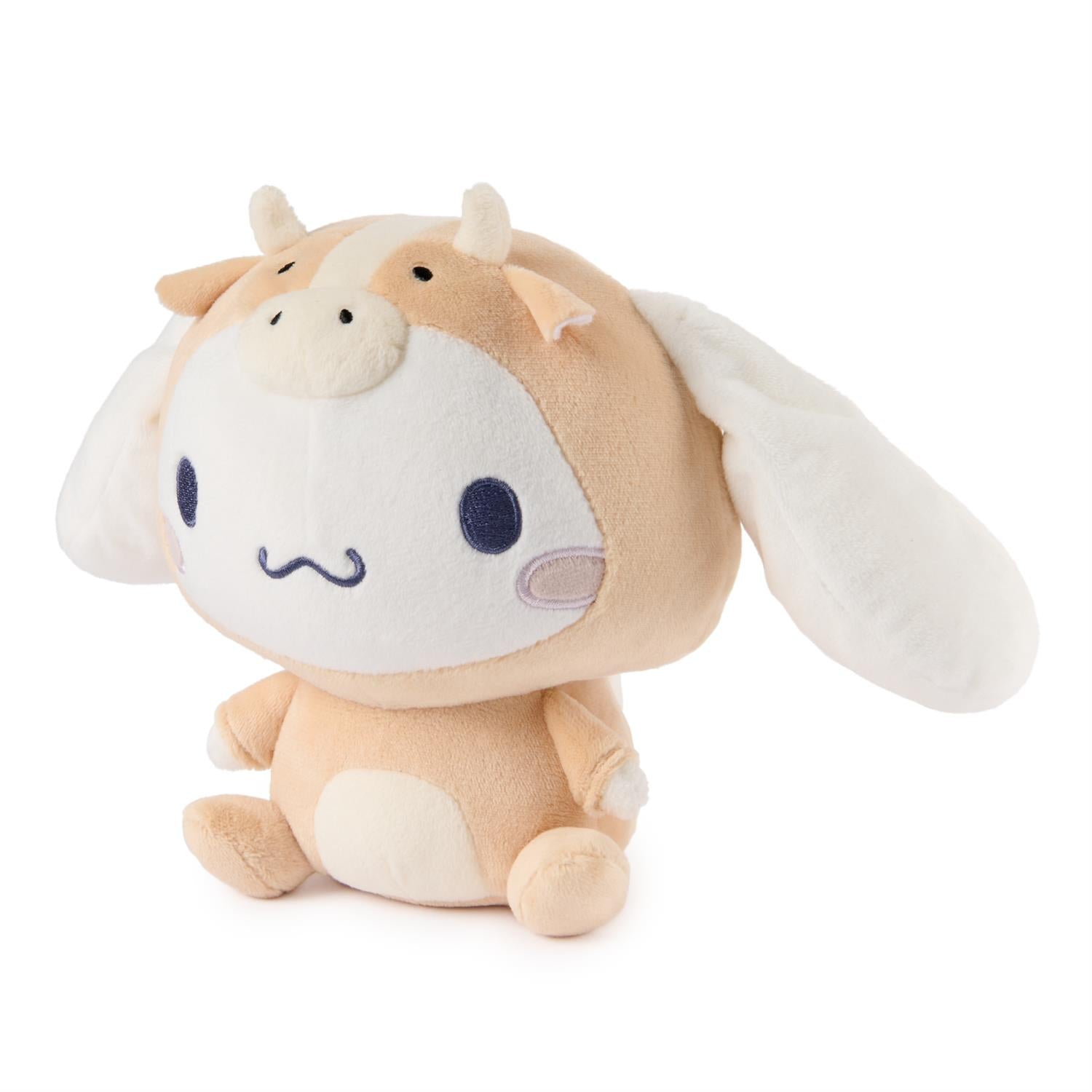 Plush toy cow with white face and brown body on a white background