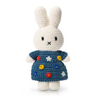 Crocheted Miffy bunny doll wearing a blue dress with floral embroidery.