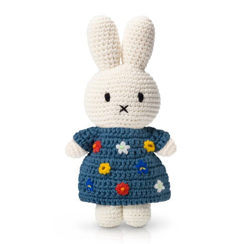 Crocheted Miffy bunny doll wearing a blue dress with floral embroidery.