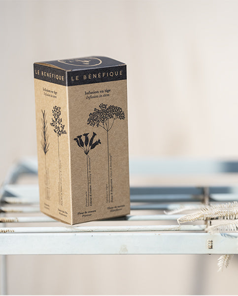 Brown and black Le Benefique tea box on a metal rack.