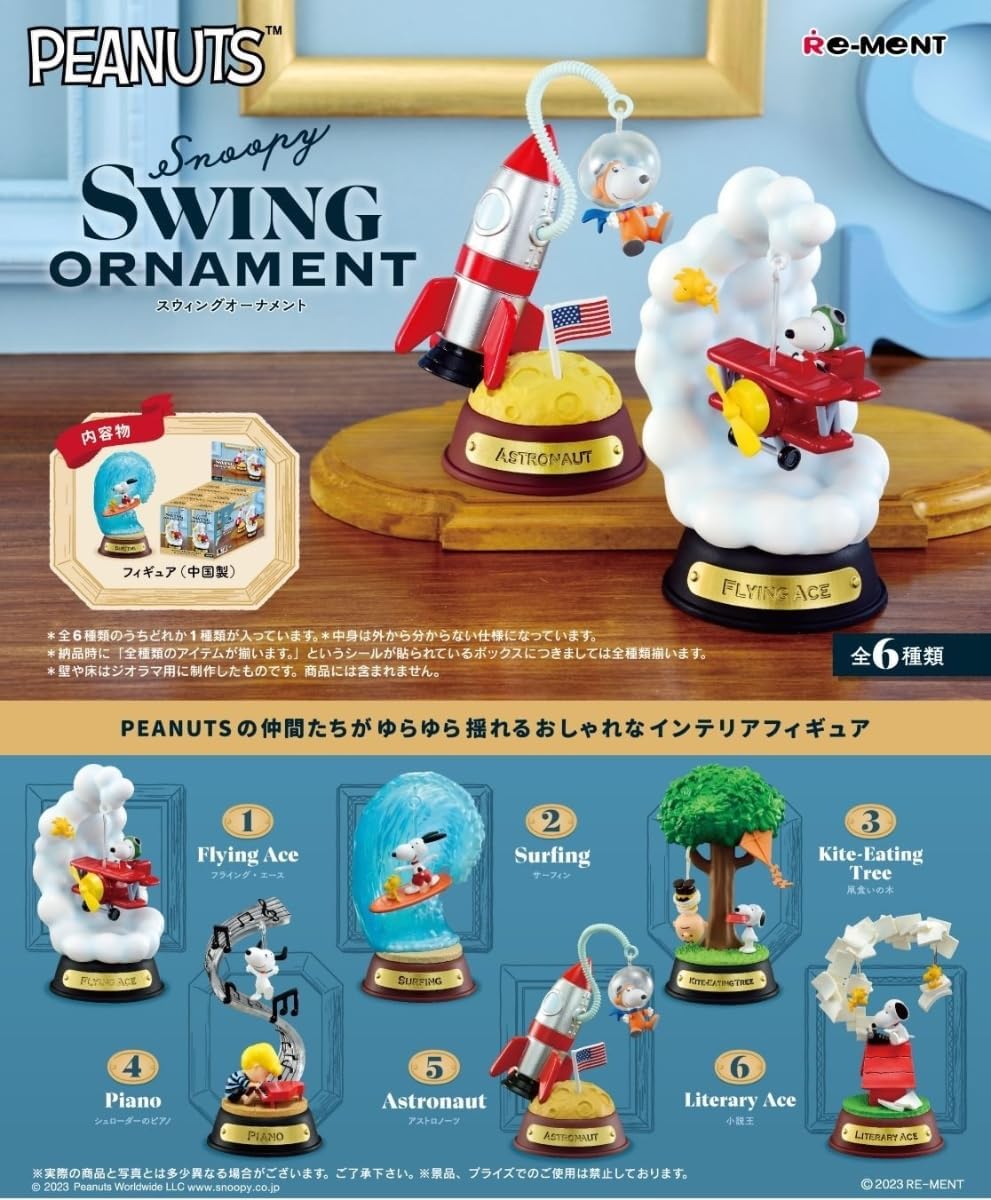 Peanuts Snoopy Swing Ornament set with various figures and decorations on a wooden surface.