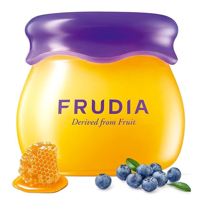 Yellow and purple jar with blueberries and honeycomb.
