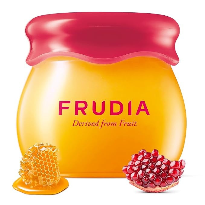 Product shot of Frudia honey and pomegranate cream in jar with fruit.