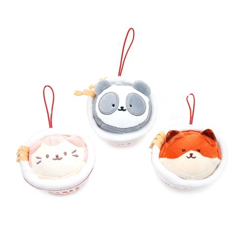 Three plush animal ornaments in bowls.