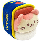 Plush toy shaped like a cat inside a Spam can.