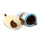 A cream-colored plush dog and a plush Hershey's Cookies 'n' Creme tunnel.