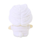 Rear view of a white plush duck toy wrapped in a white towel.
