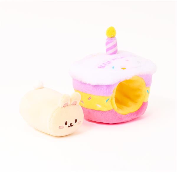 Cream-colored plush bunny next to a plush cupcake with a hole for entry.