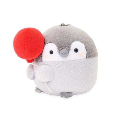 Stuffed penguin holding a red balloon.