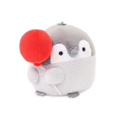 Stuffed penguin holding a red balloon.