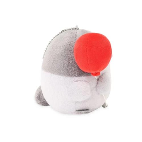 Gray and white plush penguin toy holding a red balloon.