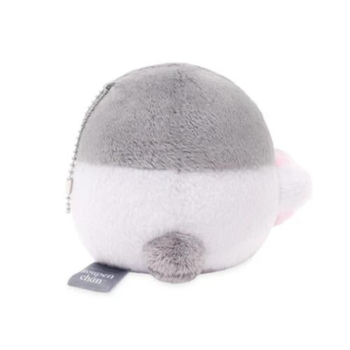 Round plush toy with grey top and white bottom, featuring a small tail and a tag.