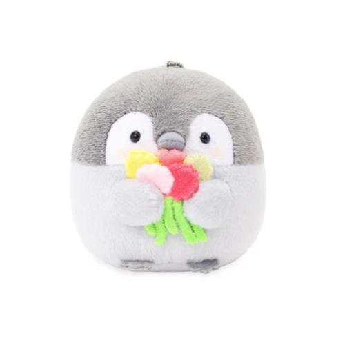 A plush toy penguin holding a bouquet of flowers.