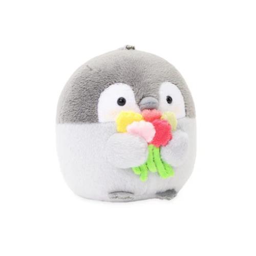 Plush penguin holding flowers.