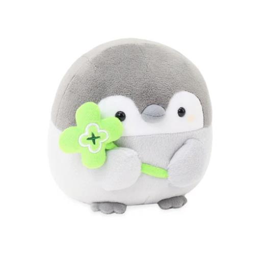 Stuffed penguin holding a green four-leaf clover.