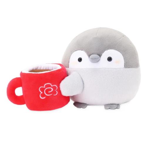 Stuffed gray penguin holding a red coffee cup with a flower on it.