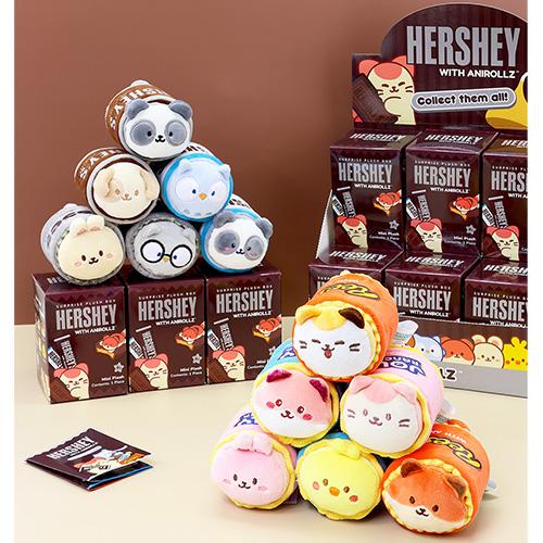 Plush Hershey's Aniroilz toys and boxes stacked on a table.