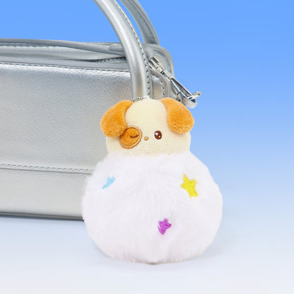 Plush dog-shaped keychain with colorful stars attached to a silver handbag on a light blue background