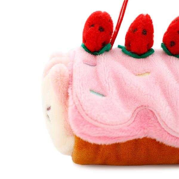 Plush toy cake slice with strawberry toppings.