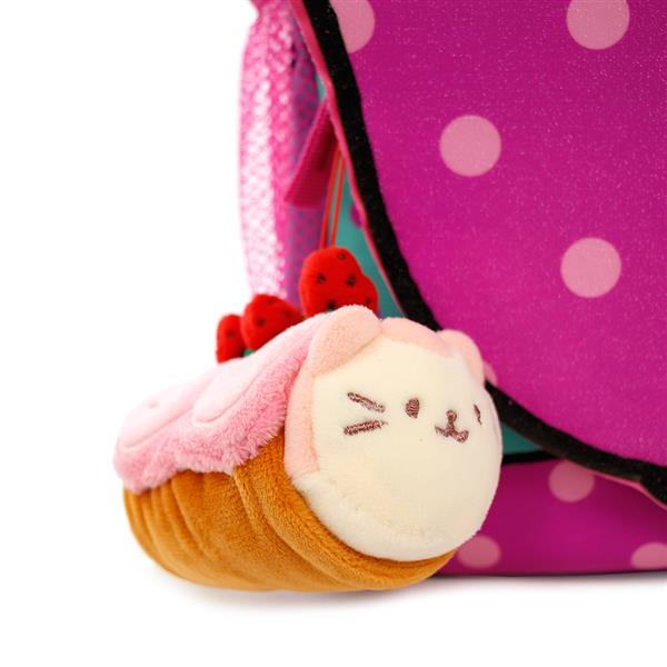 Close-up of a stuffed plush cupcake cat attached to a purple backpack with white polka dots.