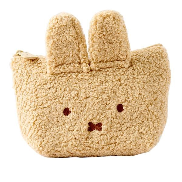 Tan, fuzzy rabbit-shaped coin purse with ears and embroidered details.